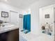 Modern bathroom with double vanity and teal accents at 1634 Reddish Egret Ct, Davenport, FL 33897