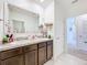 Double vanity bathroom with granite countertop at 1634 Reddish Egret Ct, Davenport, FL 33897