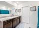 Elegant bathroom with double vanity and large mirror at 1634 Reddish Egret Ct, Davenport, FL 33897