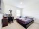 Spacious bedroom with a workspace and large bed at 1634 Reddish Egret Ct, Davenport, FL 33897