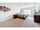 Bright bedroom featuring a king-size bed and large window at 1634 Reddish Egret Ct, Davenport, FL 33897