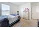 Bright bedroom with a double bed, dresser, and window at 1634 Reddish Egret Ct, Davenport, FL 33897