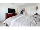 Relaxing bedroom with king bed, TV, and access to bathroom at 1634 Reddish Egret Ct, Davenport, FL 33897