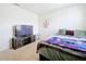 Bedroom with TV, dresser and a comfortable bed at 1634 Reddish Egret Ct, Davenport, FL 33897