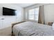 Bright bedroom with a TV, window, and comfortable bed at 1634 Reddish Egret Ct, Davenport, FL 33897