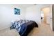 Simple bedroom with a double bed and modern art at 1634 Reddish Egret Ct, Davenport, FL 33897
