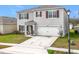 Two-story house with attached garage and red shutters at 1634 Reddish Egret Ct, Davenport, FL 33897