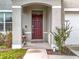 Elegant front door with arched entryway and landscaping at 1634 Reddish Egret Ct, Davenport, FL 33897