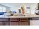 Granite kitchen island with double sink, dishwasher and seating at 1634 Reddish Egret Ct, Davenport, FL 33897