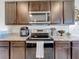 Sleek kitchen with dark wood cabinets and granite countertops at 1634 Reddish Egret Ct, Davenport, FL 33897