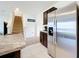 Kitchen boasts stainless steel refrigerator and ample cabinetry at 1634 Reddish Egret Ct, Davenport, FL 33897