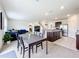 Open concept kitchen and dining area with stainless steel appliances and an island at 1634 Reddish Egret Ct, Davenport, FL 33897