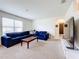 Spacious living room with sectional sofa and large TV at 1634 Reddish Egret Ct, Davenport, FL 33897