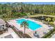 Relaxing community pool with surrounding lounge chairs and landscaping at 1634 Reddish Egret Ct, Davenport, FL 33897