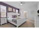Main bedroom with white furniture, purple walls, and en-suite bathroom at 2190 Lelani Cir, Davenport, FL 33897