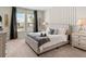 Spacious bedroom with tufted headboard, neutral decor, and ample natural light at 2190 Lelani Cir, Davenport, FL 33897