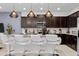 Modern kitchen with dark cabinets, granite counters, and island seating at 2190 Lelani Cir, Davenport, FL 33897
