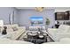 Spacious living room with off-white sofas and a large flat-screen TV at 2190 Lelani Cir, Davenport, FL 33897