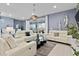 Living room with off-white sofas and access to a back patio at 2190 Lelani Cir, Davenport, FL 33897