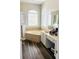 Large bathroom with a corner tub, double vanity, and wood-look tile at 2304 Cedar Garden Dr, Orlando, FL 32824
