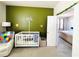 Bedroom with crib, colorful decor, and access to another room at 2304 Cedar Garden Dr, Orlando, FL 32824