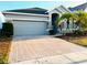 One story home with gray siding, herringbone driveway, and palm trees at 2304 Cedar Garden Dr, Orlando, FL 32824