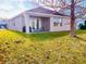 Single-story home with backyard patio and lake view at 2304 Cedar Garden Dr, Orlando, FL 32824