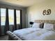 Spacious main bedroom with lake view and striped bedding at 2304 Cedar Garden Dr, Orlando, FL 32824