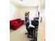 Home office features a red couch and workspace at 2304 Cedar Garden Dr, Orlando, FL 32824