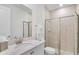 Bathroom featuring a glass-enclosed shower, white vanity, and a large mirror at 2929 Caribbean Soul Dr, Kissimmee, FL 34747