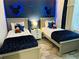 Charming bedroom with twin beds, starry wallpaper, and decorative Mickey Mouse accents at 2929 Caribbean Soul Dr, Kissimmee, FL 34747