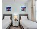 Bright bedroom with two twin beds and colorful beach themed decor at 2929 Caribbean Soul Dr, Kissimmee, FL 34747