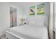 Inviting bedroom with a queen-size bed, ensuite bathroom, and bright decor at 2929 Caribbean Soul Dr, Kissimmee, FL 34747