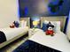 Themed bedroom featuring two twin beds and custom Mickey Mouse wall decor at 2929 Caribbean Soul Dr, Kissimmee, FL 34747