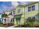 Colorful two story townhouse with tropical landscaping and a covered front entrance at 2929 Caribbean Soul Dr, Kissimmee, FL 34747