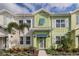 Inviting two-story townhome with colorful shutters, front yard landscaping, and a welcoming entryway at 2929 Caribbean Soul Dr, Kissimmee, FL 34747