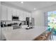 Bright, modern kitchen features a large island, stainless appliances, and plenty of cabinet space at 2929 Caribbean Soul Dr, Kissimmee, FL 34747