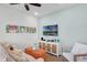 Relaxing living room with vibrant artwork, a flat-screen TV, and comfortable seating at 2929 Caribbean Soul Dr, Kissimmee, FL 34747