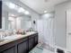 Double vanity bathroom with shower and patterned curtain at 3033 Sangria St, Kissimmee, FL 34744