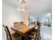 Bright dining area with wood table and chairs, chandelier, and view into living room at 3033 Sangria St, Kissimmee, FL 34744