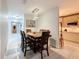 Open dining area with wood table and chairs, adjacent to kitchen and hallway at 3033 Sangria St, Kissimmee, FL 34744