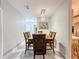 Dining area featuring a wood table and chairs, stylish chandelier, and view into kitchen at 3033 Sangria St, Kissimmee, FL 34744