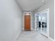 Bright entryway with orange door and view into an office at 3033 Sangria St, Kissimmee, FL 34744