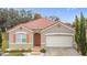 One-story house with terracotta roof and attached garage at 3033 Sangria St, Kissimmee, FL 34744