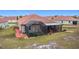 Backyard features a screened patio, artificial turf, and red pavers at 3033 Sangria St, Kissimmee, FL 34744
