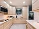 Modern kitchen with light wood cabinets, stainless steel appliances, and quartz countertops at 3033 Sangria St, Kissimmee, FL 34744