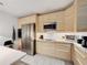 Modern kitchen featuring stainless steel appliances and light wood cabinets at 3033 Sangria St, Kissimmee, FL 34744