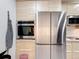 Modern kitchen with stainless steel appliances and light wood cabinets at 3033 Sangria St, Kissimmee, FL 34744