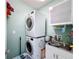 Stackable washer and dryer in a well-lit laundry room at 3033 Sangria St, Kissimmee, FL 34744