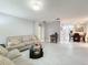 Spacious living area with couches, coffee table, and view to dining area at 3033 Sangria St, Kissimmee, FL 34744